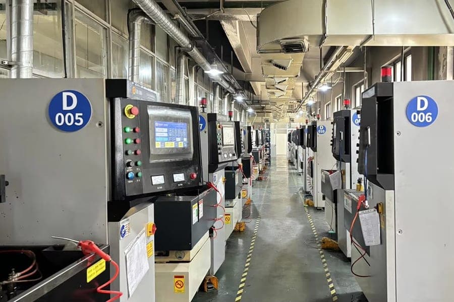 A row of numbered electrical-discharge machining units on the factory floor