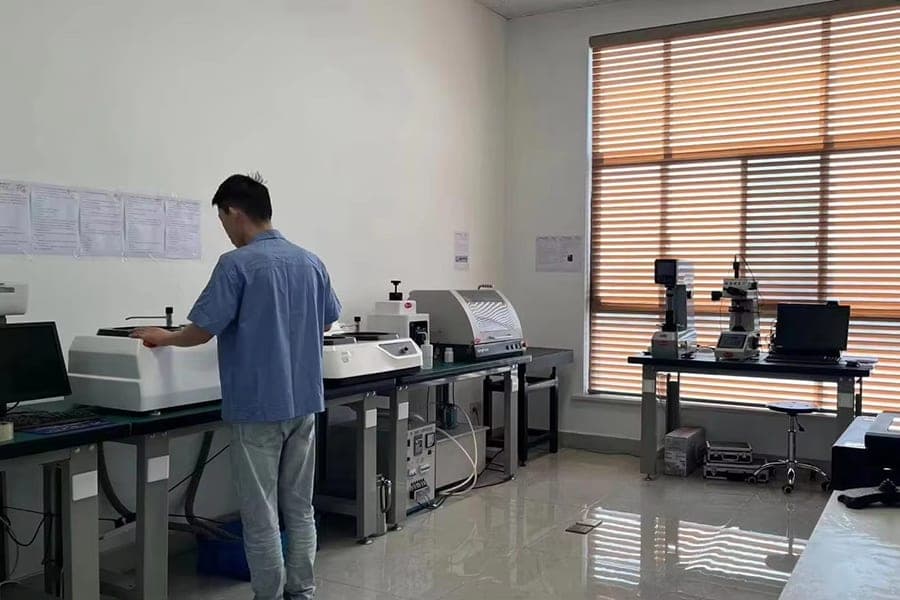 Technician operating inspection equipment in a factory work area