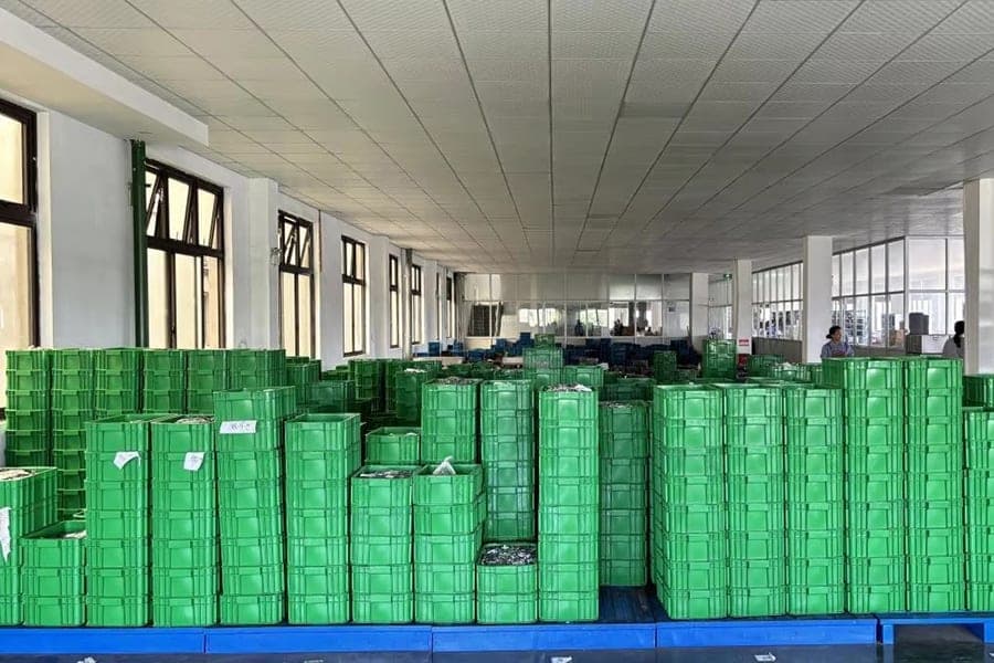 Parts arranged in green bins in an in-process storage area